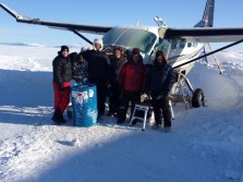 A Team Of Aviation Specialists In Front Of An Airplane In The Snow